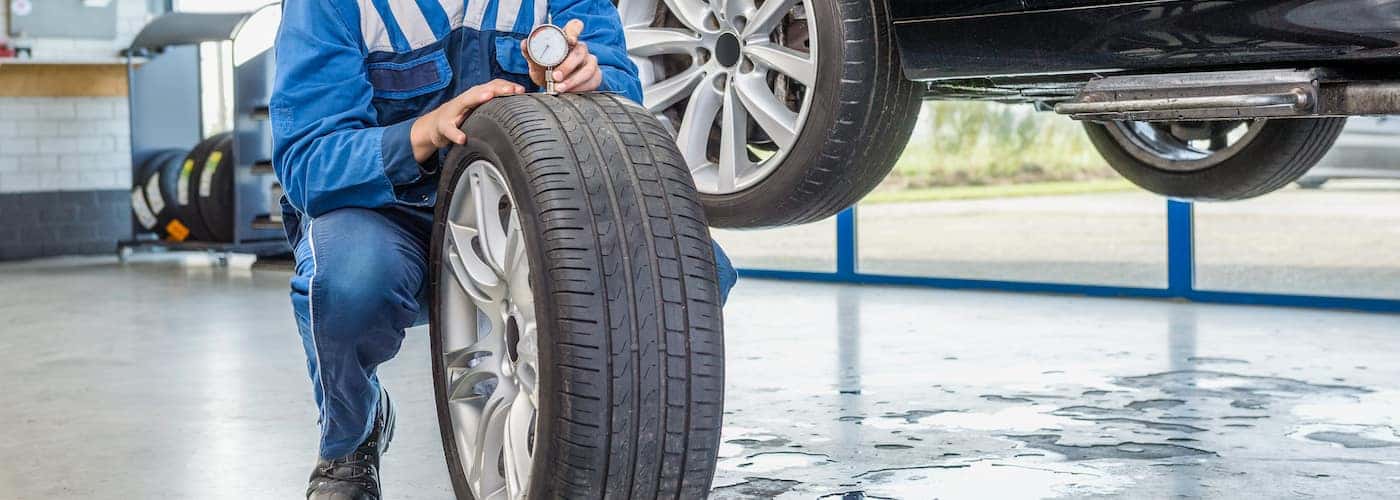 mechanic checking tire tread close up
