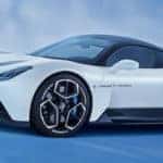A white 2022 Maserati MC20 in front of a blue background
