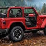 side view of red 2020 jeep wrangler near lake