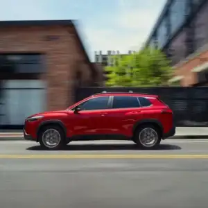 2026 Toyota Corolla Cross Soul Red Crystal in motion