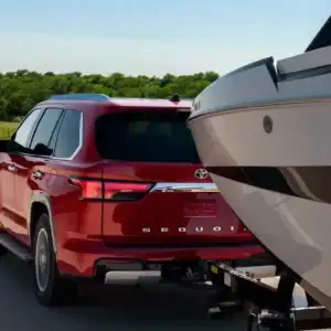 2026 Toyota Sequoia red towing a boat