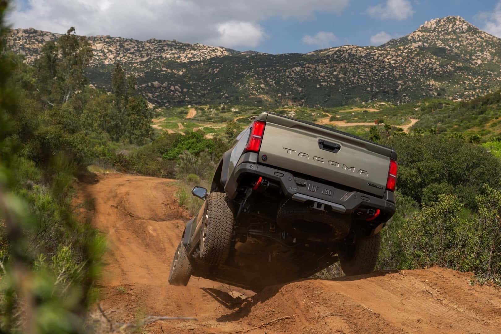 The Adventurous And Reliable Toyota Tacoma Trailhunter Jumping Over A Hill