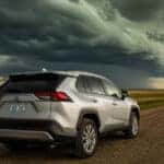 2022 Toyota RAV4 AWD on a South Dakota county road with storm clouds building overhead