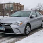 Used Toyota Camry parked on a snowy Watertown SD street in winter