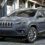 Blue gray Jeep Cherokee parked on cobble stone road