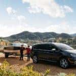 black 2021 chrysler pacifica towing a boat