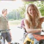 happy woman unloading cooler from trunk