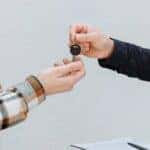 One person handing keys to another person