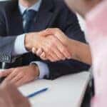 A finance guy and customer shaking hands