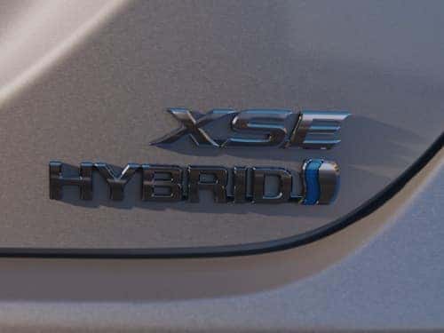 2024 Toyota Camry close up view of hybrid emblem on trunk of car