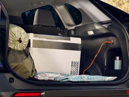 2024 Toyota RAV4 view of cargo area full of camping supplies and usage of 12V outlet