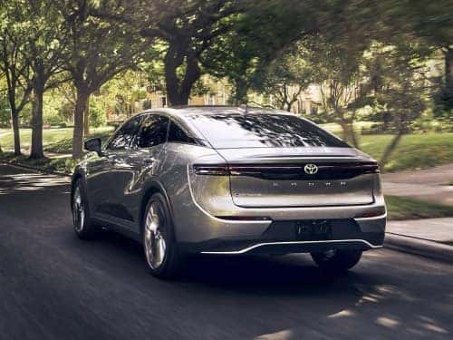 2024 Toyota Crown exterior rear view of car driving down a neighborhood street