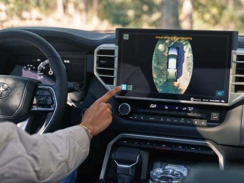 2024 Toyota Tundra man touching touchscreen with rear camera displaying