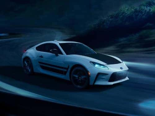 2024 Toyota GR86 side view of car driving on a windy road at night