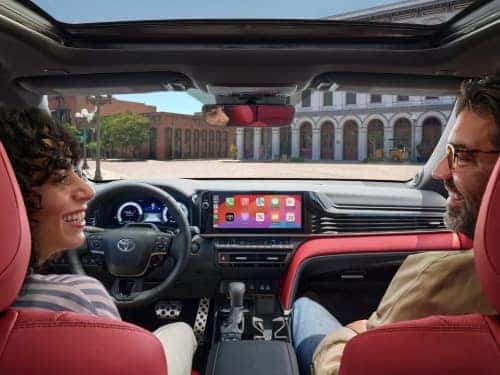 2025 Toyota Camry view from behind of couple in front two seats and dash area