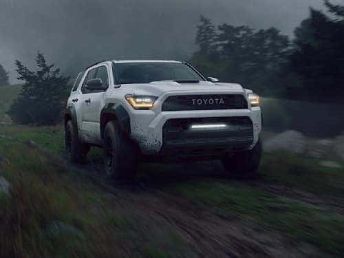 2025 Toyota 4runner offroading on a muddy trail on a foggy day
