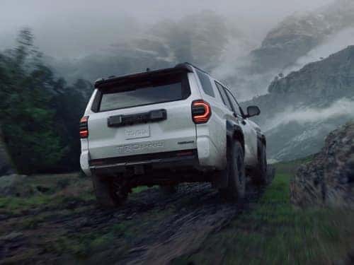 2025 Toyota 4runner rear exterior view of vehicle driving on a muddy trail