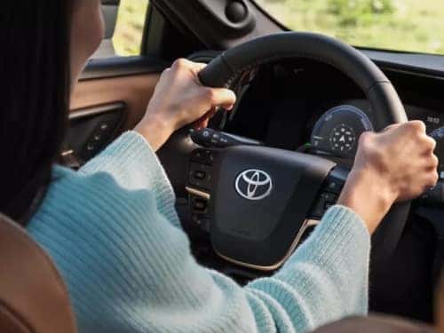2025 Toyota Crown Insignia close up view of woman holding steering wheel